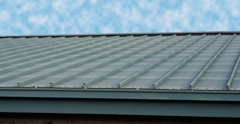 A steel roofing reflecting the blue sky.